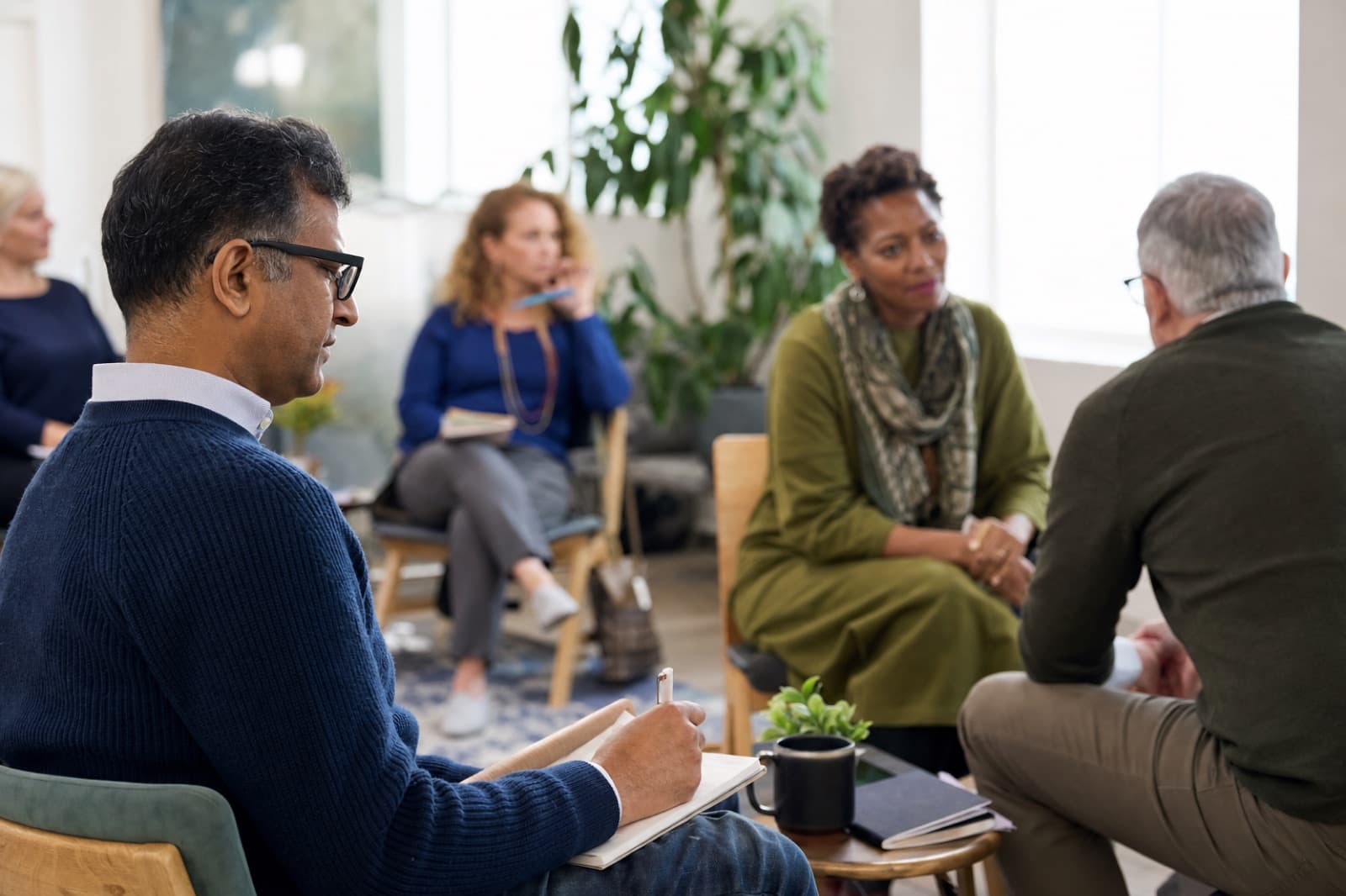 Adults practicing coaching skills in a professional training workshop
