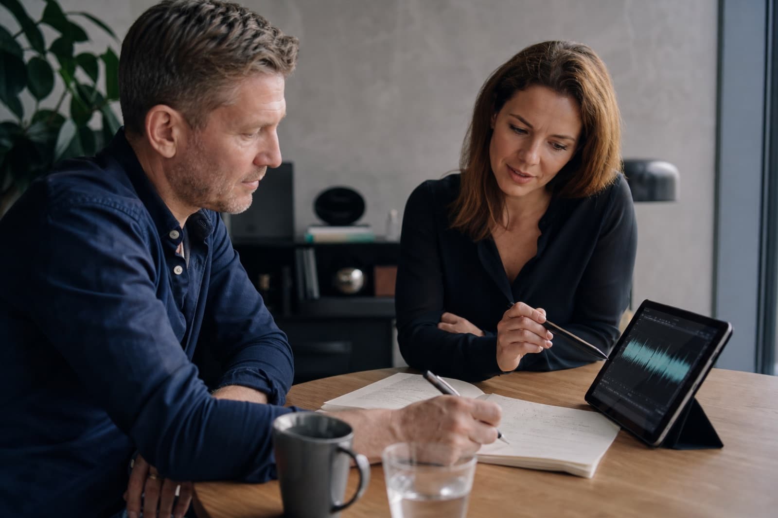 Two professionals reviewing coaching observations at a table