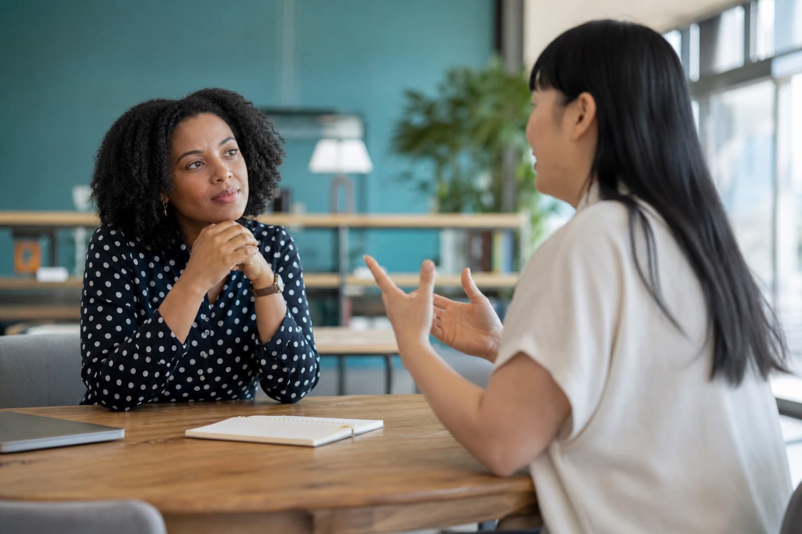 Two adults demonstrating attentive listening during a professional conversation